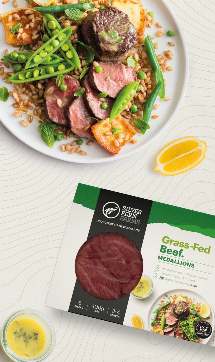 beef medallion salad next to a lemon wedge and a package of grass-fed beef medallions
