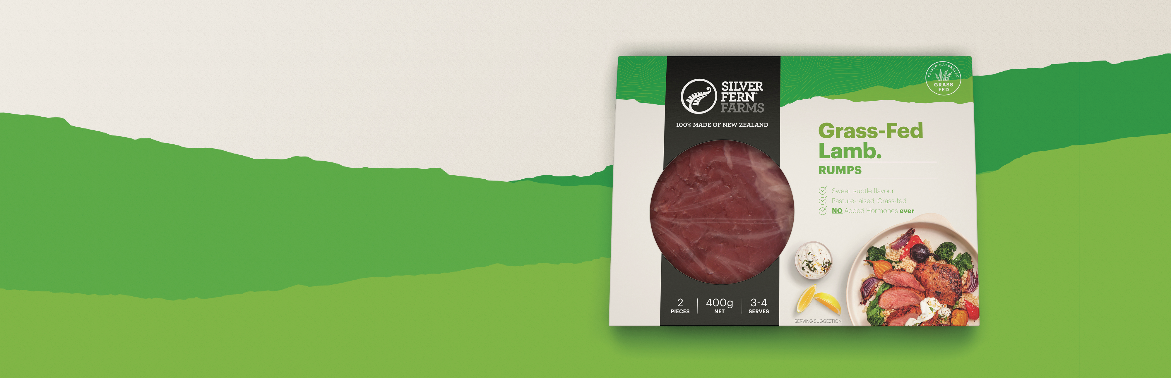grass-fed lamb rump packaging on an illustrated background of green hills