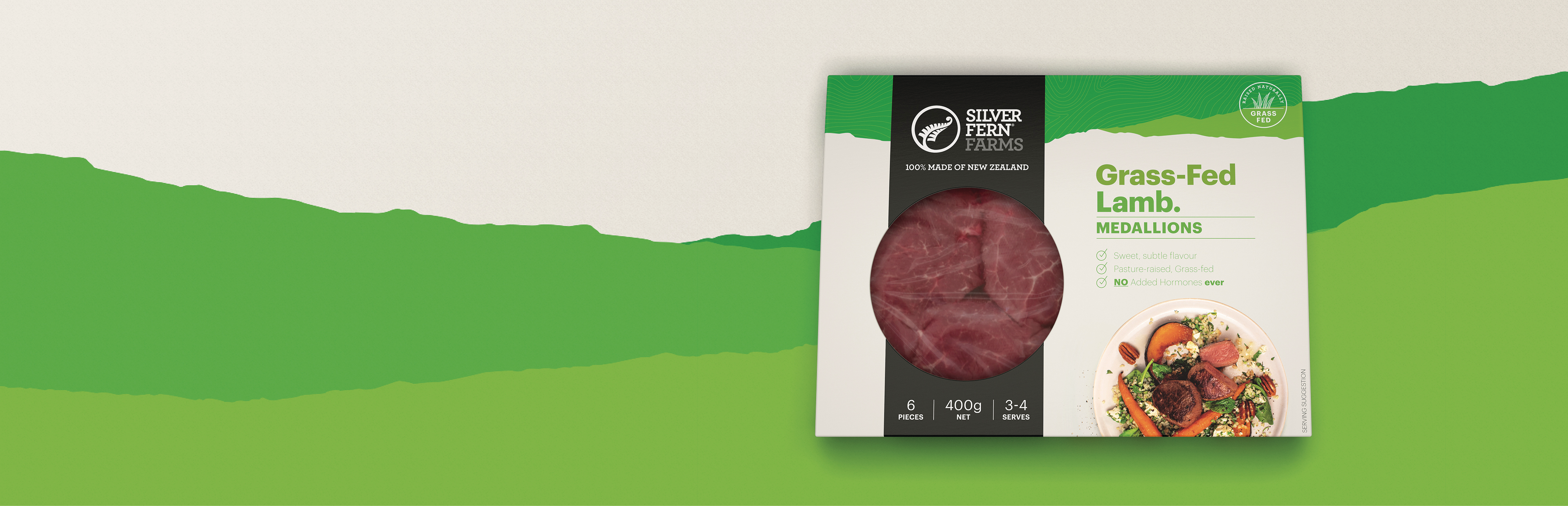 grass-fed Lamb Medallion packaging in front of an illustration of green hills