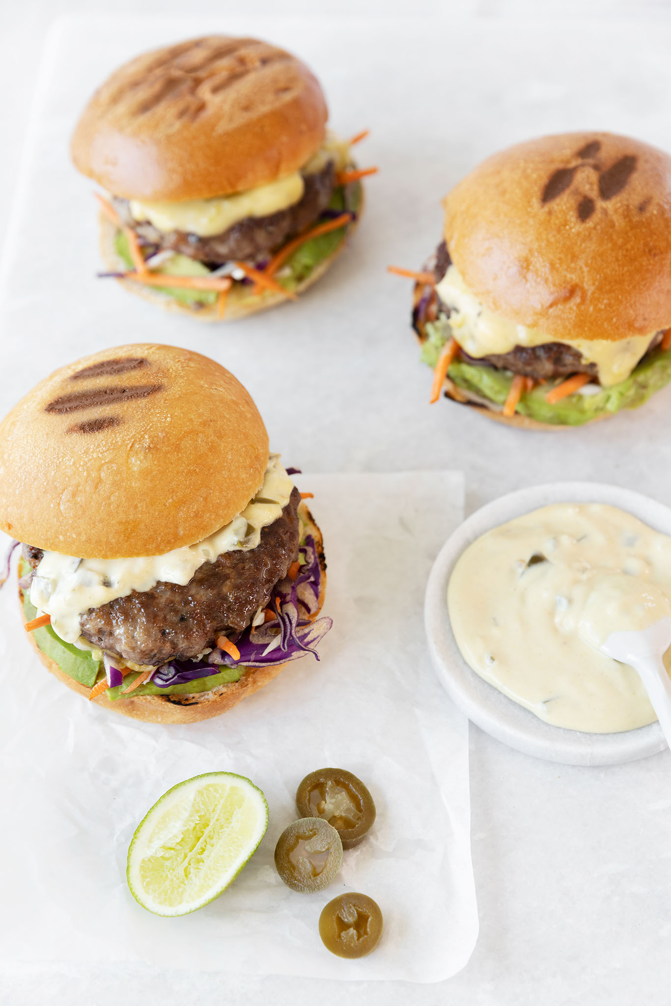 Mexican Queso Beef Burgers with Rump next to sauce