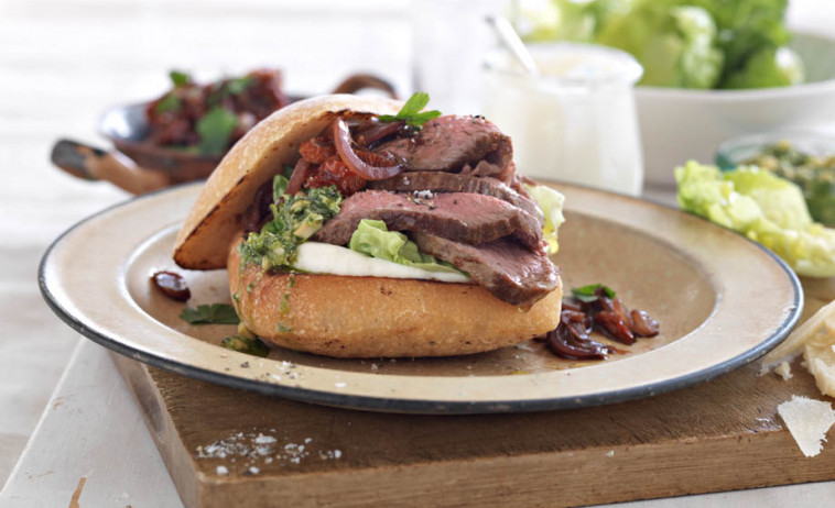 Lamb Rump Open Burger Served with Parsley Pesto on a white plate