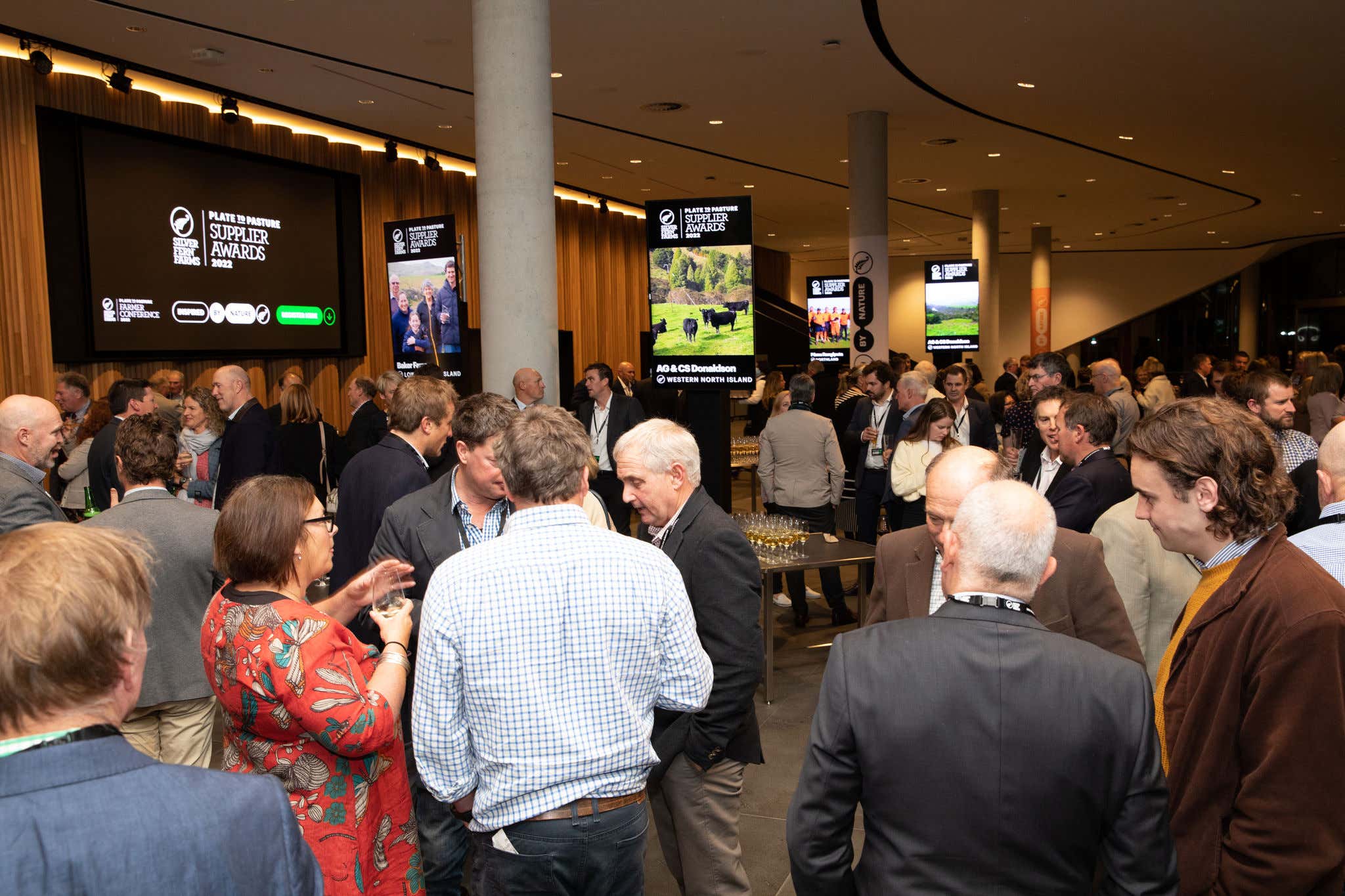 The auditorium at Te Pae Convention Centre, full of attendees at the 2022 Farmer Conference. They are watching the stage where a presentation is occurring. 