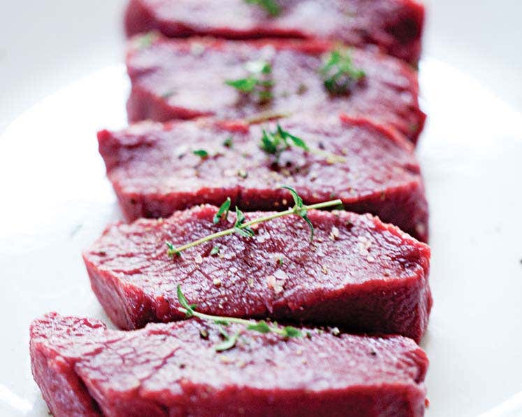 Raw meat with herbs on top