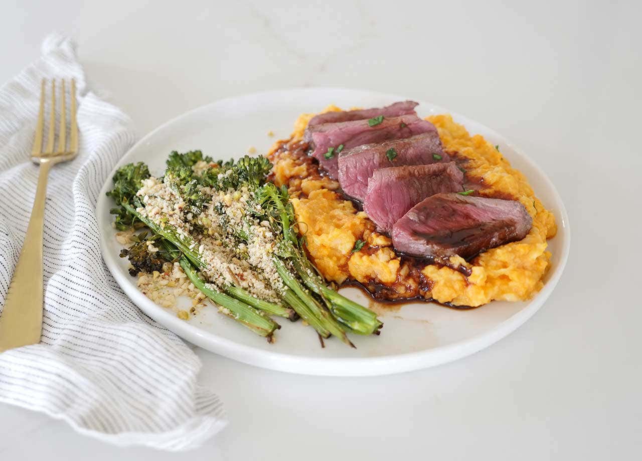 Herb-seared Venison Medallions with Creamy Root Veggie Mash and Roasted Broccolini