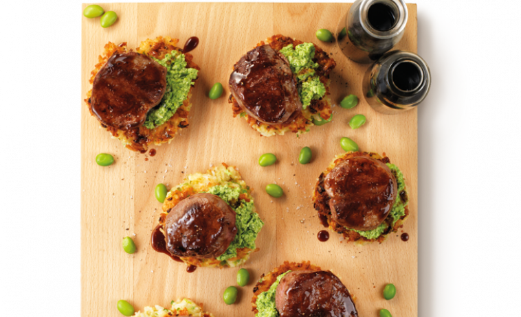 Beef Medallions on Rice Cakes with Teriyaki Sauce on a chopping board
