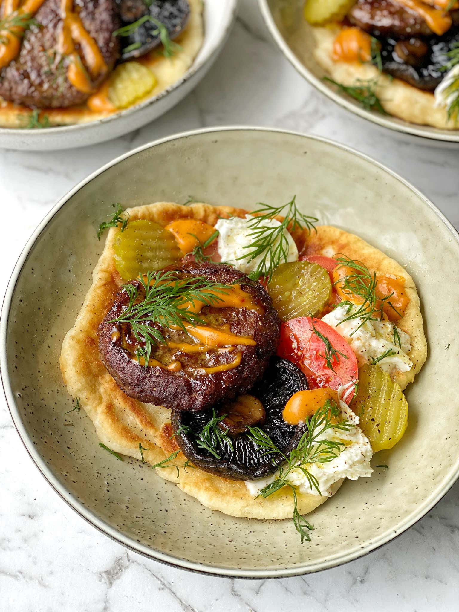 Yoghurt Flatbread Lamb Burgers with Portobello Mushroom, Buffalo Mozzarella, Tomatoes, and Gherkins