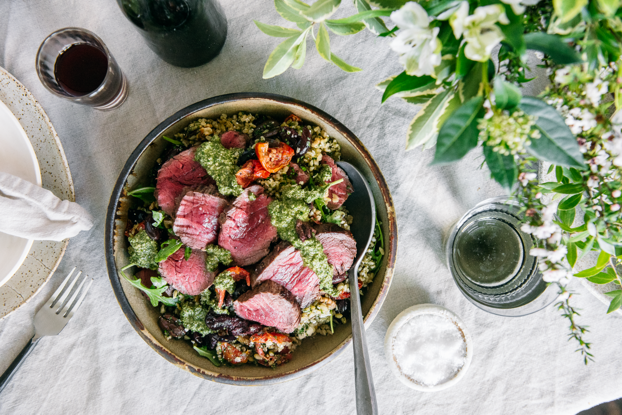 Quick Roasted Beef Eye Fillet with a Warm Winter Freekah Salad in a brown bowl