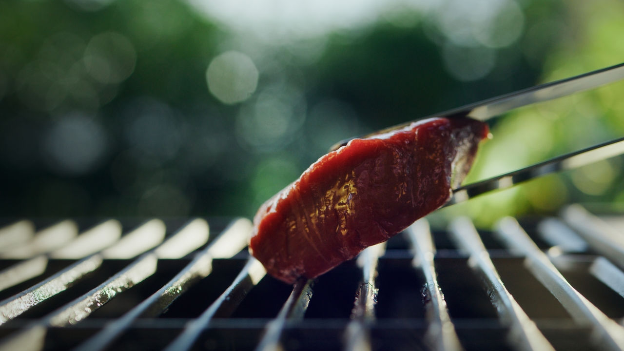 use tongs to avoid puncturing the steak and keep those delicious juices sealed in