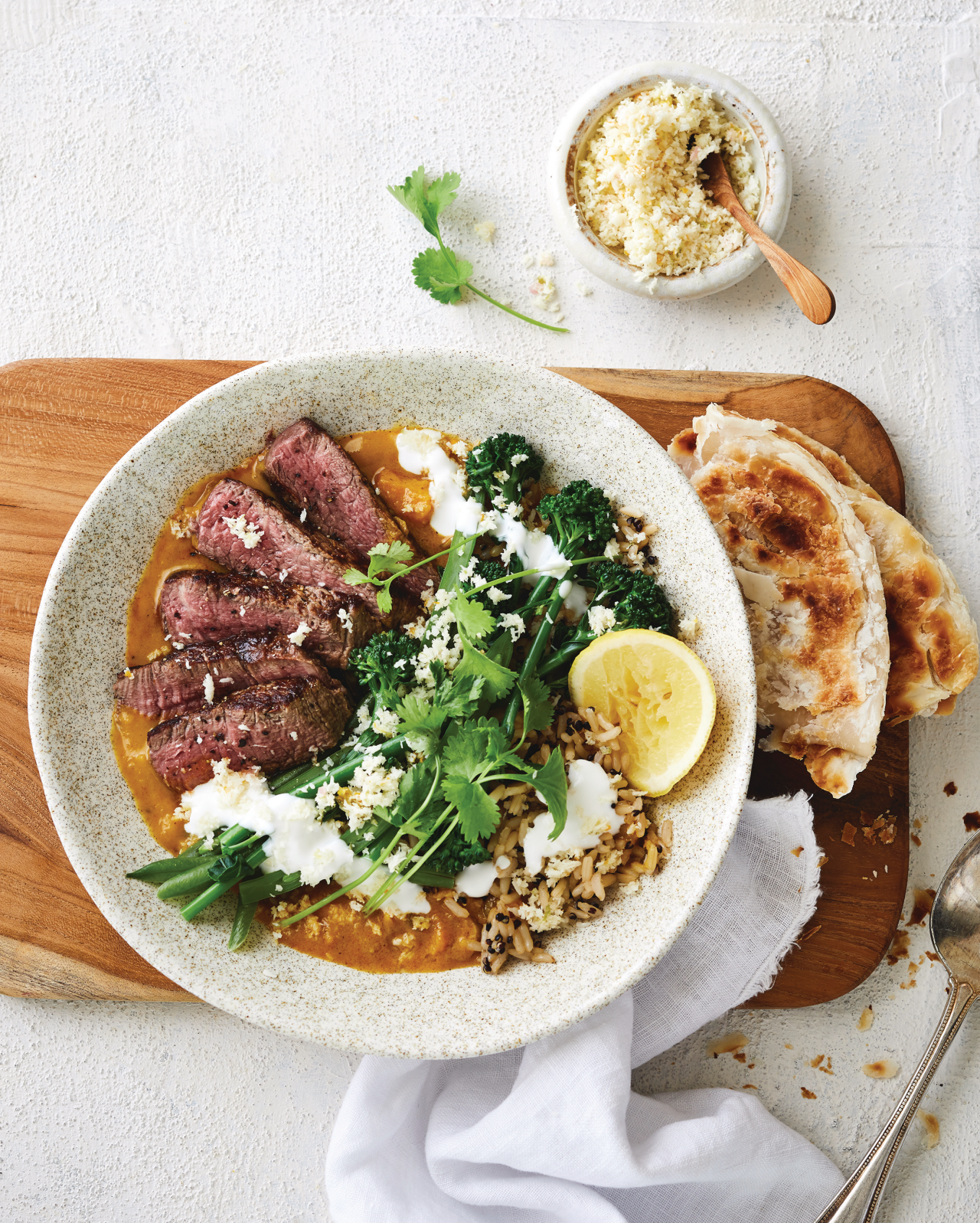 Sweet Potato and Coconut Curry with Eye Fillet Steaks in a white bowl