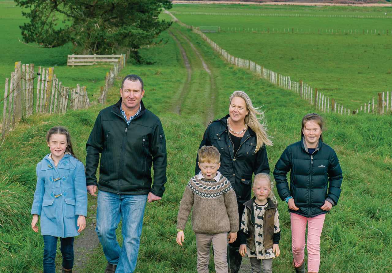 the mckelvie family walking in a field