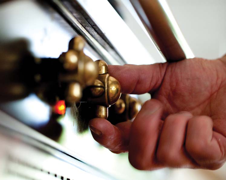 Picture of a hand turning an element on to heat up