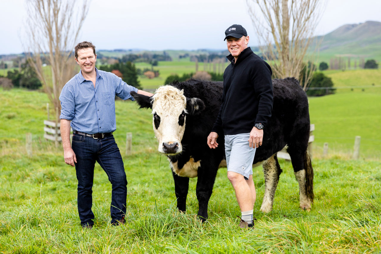 Will Foley and Livestock Rep Richard standing beside a beef animal.