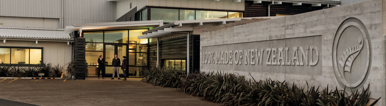 A Silver Fern Farms Office with lights on in the building and a prominent logo