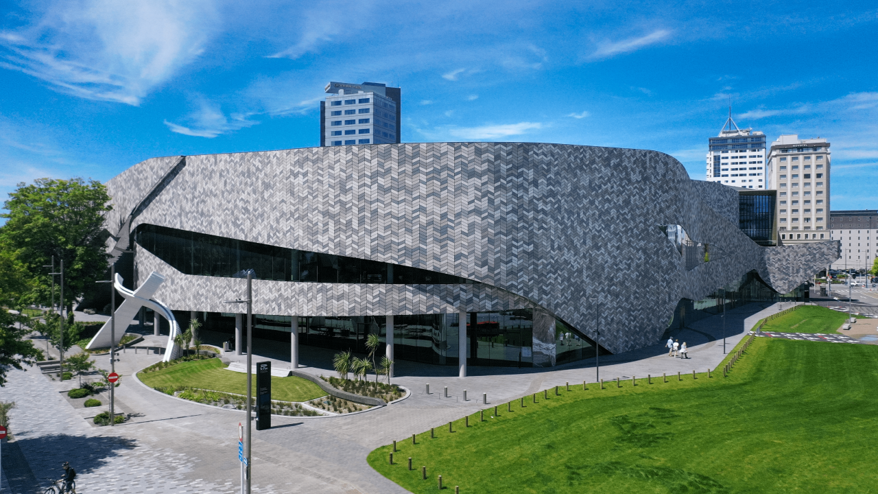 The Te Pae Convention Centre, a large square building with a tiled facade in grey and white