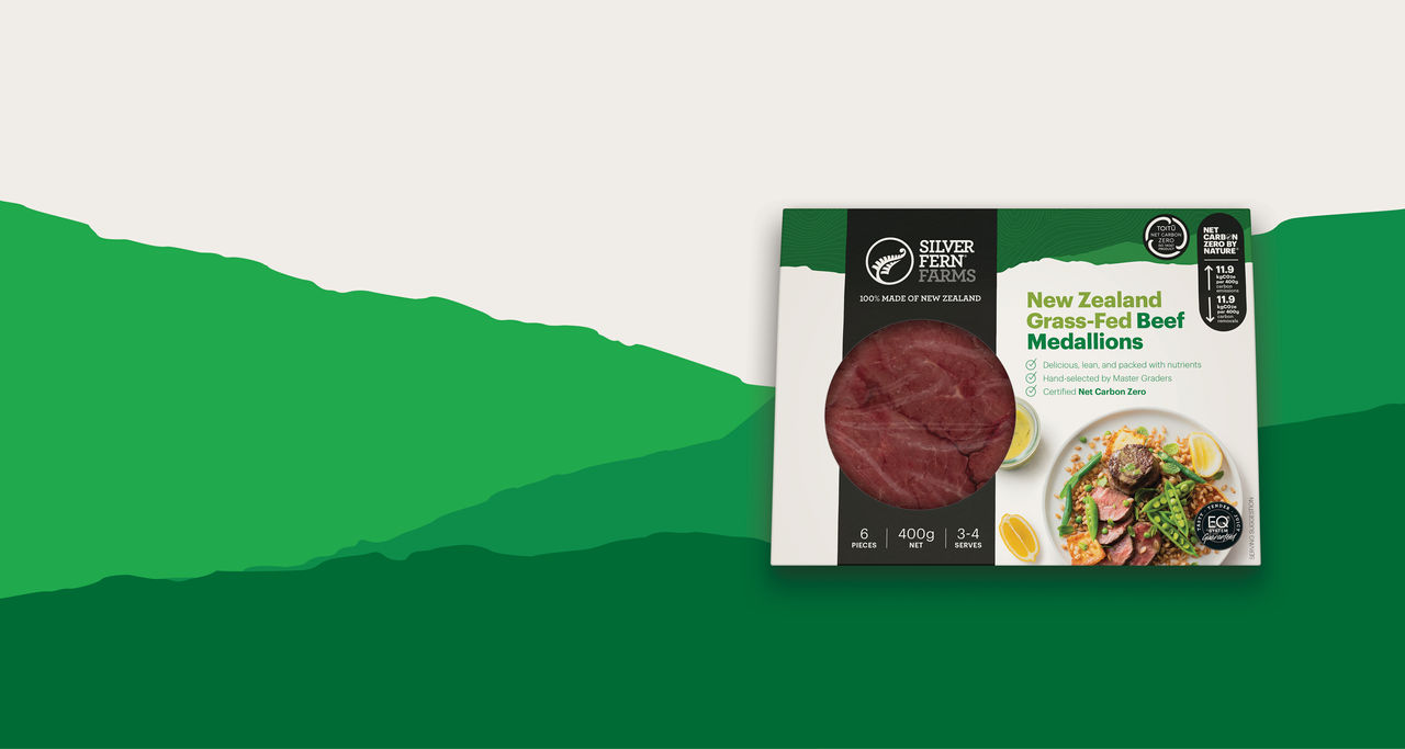 grass-fed beef medallions packaging on an illustrated background of green hills