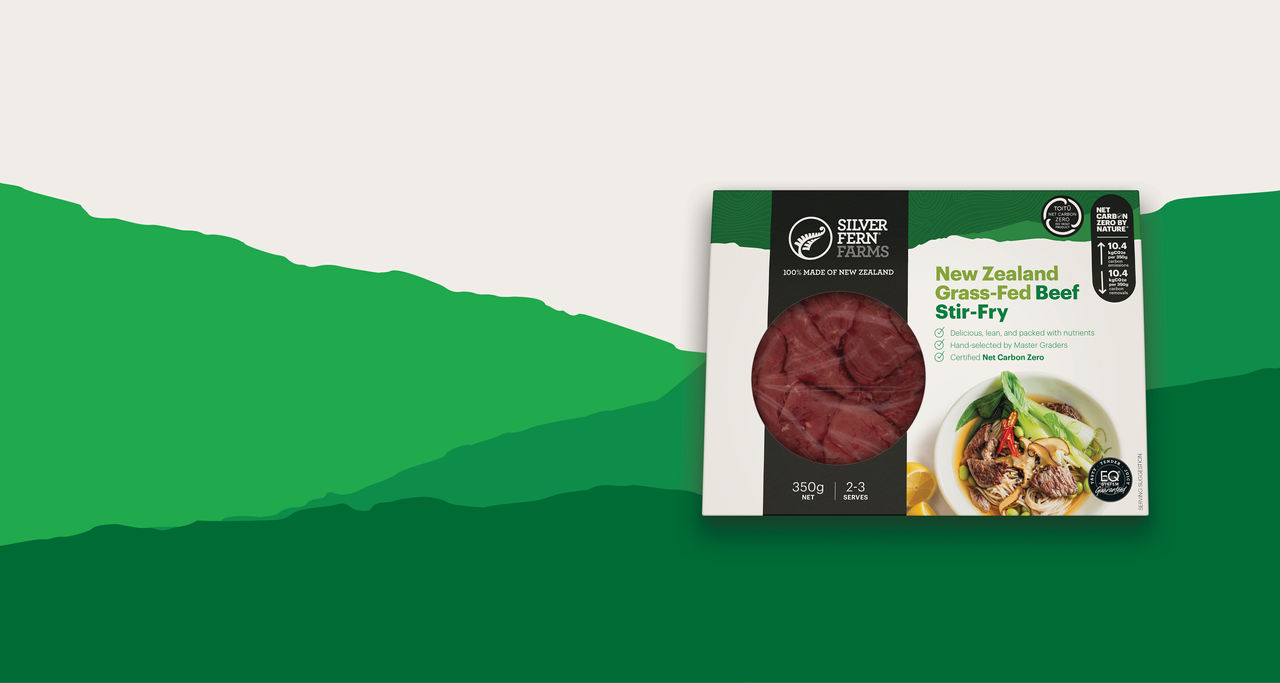 grass-fed beef stir-fry packaging on an illustrated background of green hills