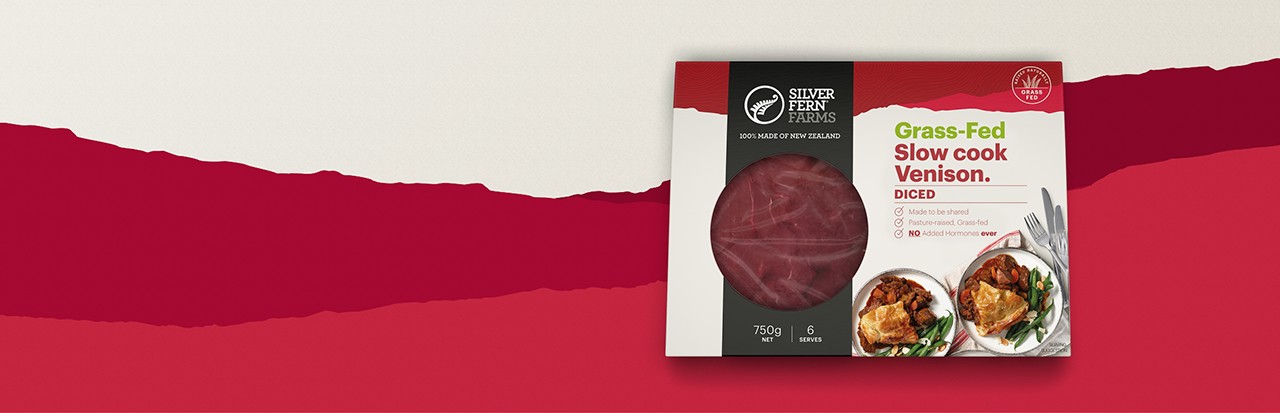 grass-fed slow cook venison diced packaging on an illustrated background of red hills