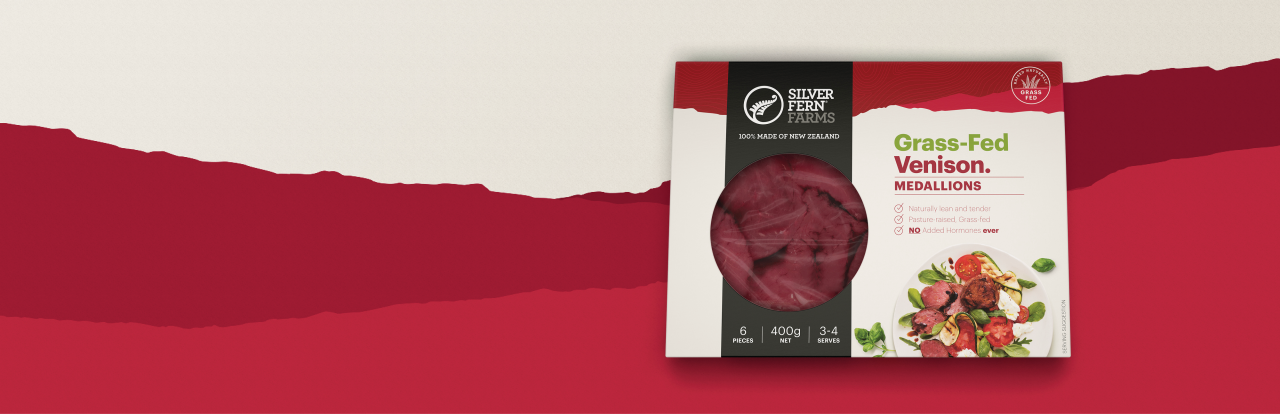 grass-fed venison medallions packaging on an illustrated background of red hills