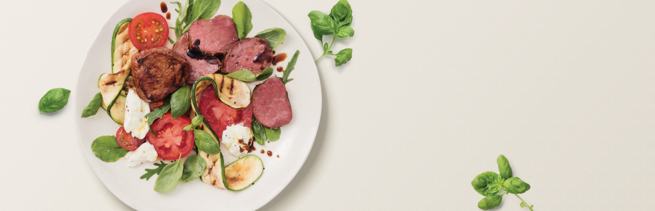 a venison medallion dish on a white plate