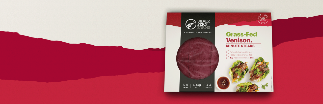 grass-fed venison minute steaks packaging on an illustrated background of red hills
