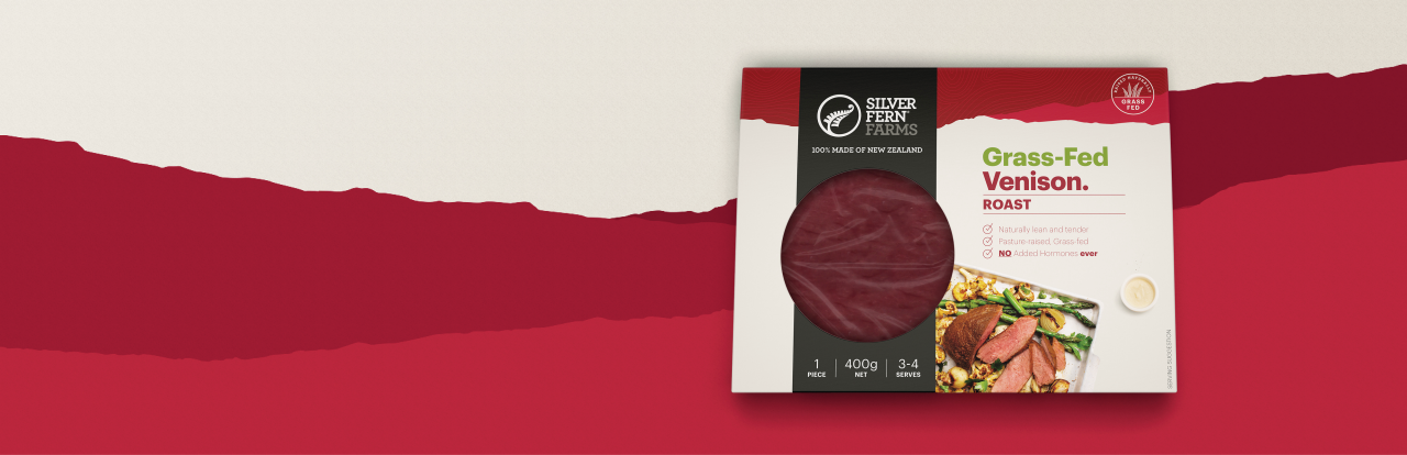 grass-fed venison roast packaging on an illustrated background of red hills