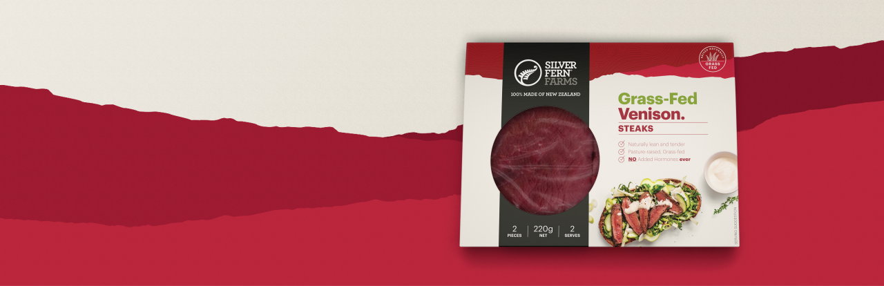 grass-fed venison steak packaging on an illustrated background of red hills