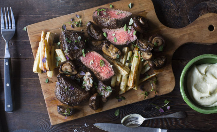 Beef Medallions with Horowhenua parsnips, Parkvale mushrooms and wasabi mayonnaise on a chopping board