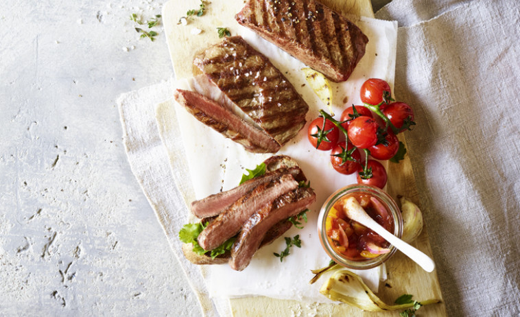 Flat-Iron Steaks with Tomatoes and Chilli Chutney on a white cloth