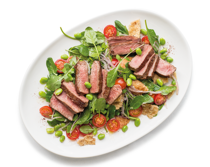 Mediterranean Beef Eye Fillet Steaks with Broad Bean Fattoush and Whipped Feta on a white plate