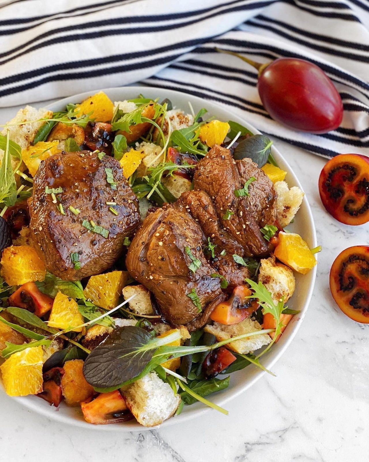 Pomegranate Molasses Lamb Rumps with Tamarillo, Orange, Torn Bread, and Mesclun