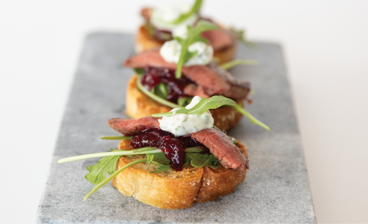 Venison Minute Steak Bruschetta on a grey marble board