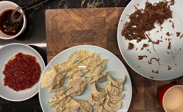 Venison Pot Stickers with Tomato Chili Jam and Soy Grastrique on a chopping board