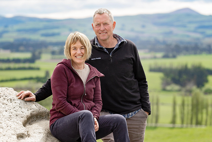 Farmers: Fiona and Nelson Hancox sitting on a rock on their farm