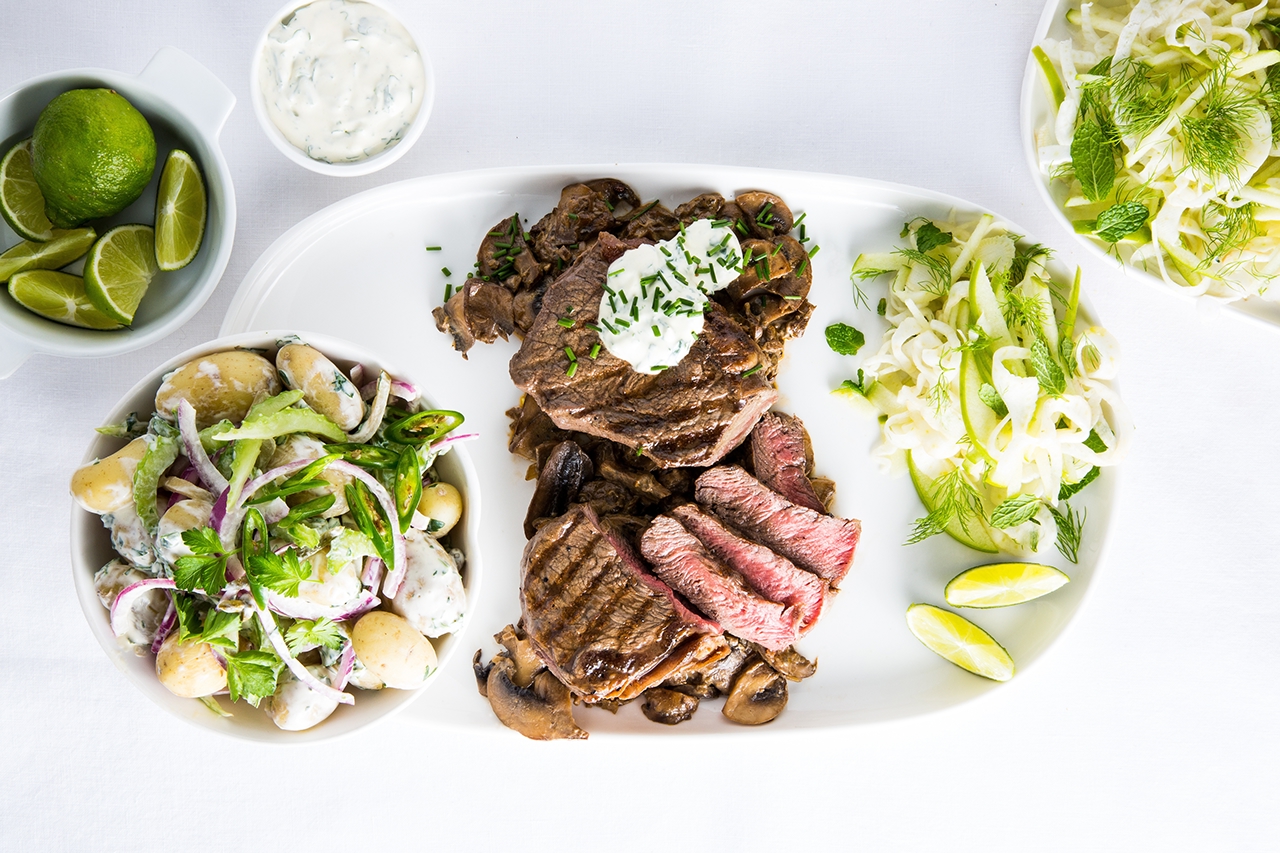 Beef New York Strip Steaks with mushroom sauce, fennel slaw and potato salad dish