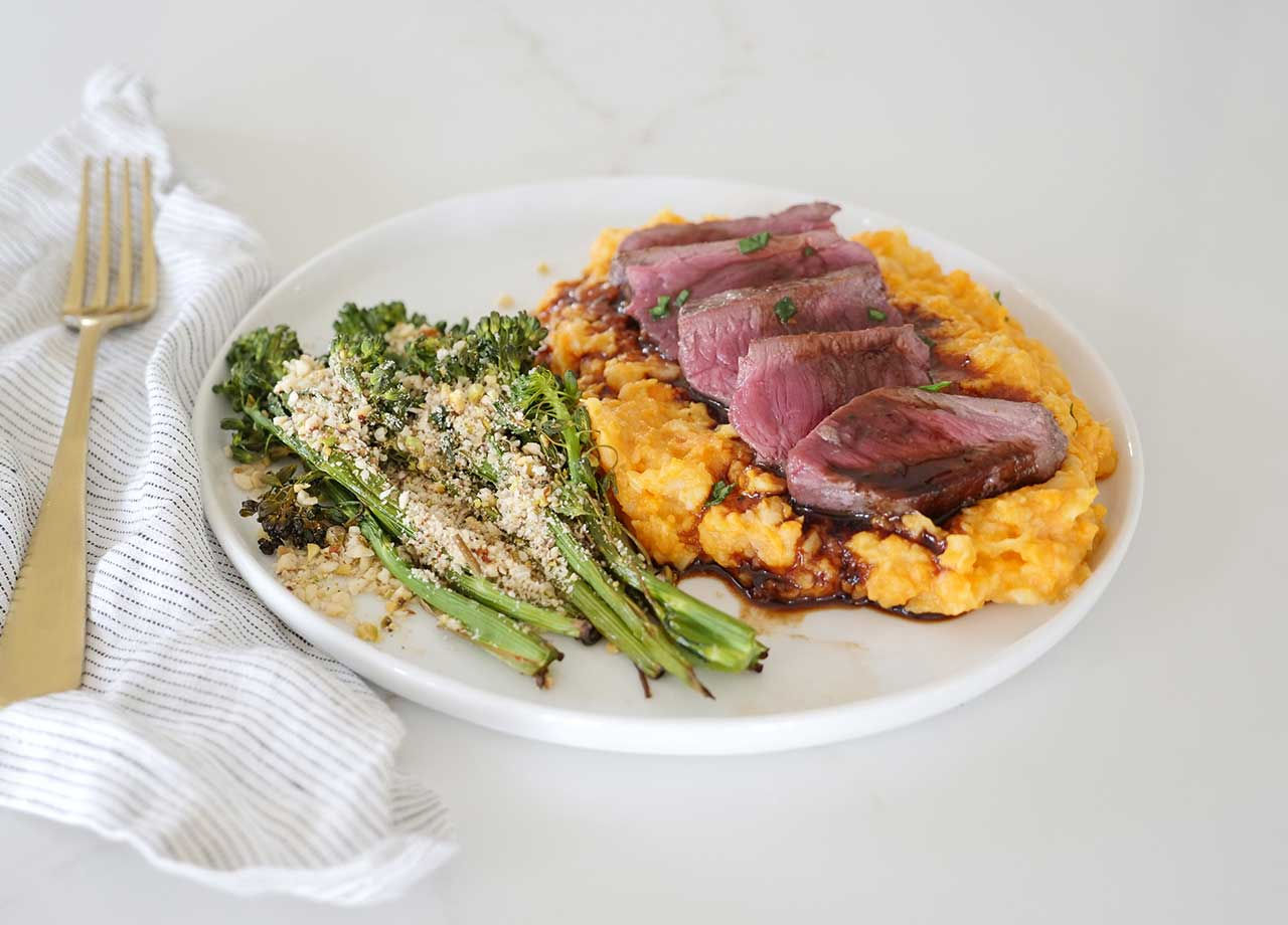 Herb-seared Venison Medallions with Creamy Root Veggie Mash and Roasted Broccolini
